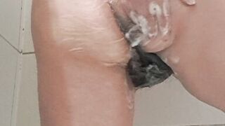 Mature milf bathing her tits and hairy pussy gets excited by the water