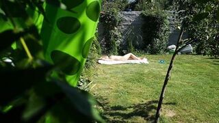 I spy on my stepmother, she is sunbathing naked in the yard