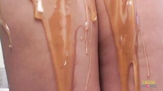 A guy with a dildo drills a milfs ass while she gives him a blowjob.