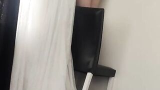 Sexy beautiful woman wearing completely nude curtains in her home.