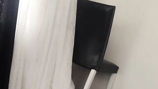 Sexy beautiful woman wearing completely nude curtains in her home.