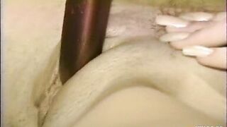 Horny Blonde Enjoys Playing with Her Bush on the Bed Using a Toy