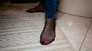 Feet in black stockings and jeans