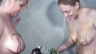 Horny chicks cover each other's naked bodies with paint in the shower